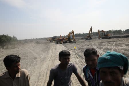 Excavators are seen in the Vashan Char, previously known as Thengar Char island in the Bay of Bengal, Bangladesh February 14, 2018. Picture taken February 14, 2018. REUTERS/Stringer