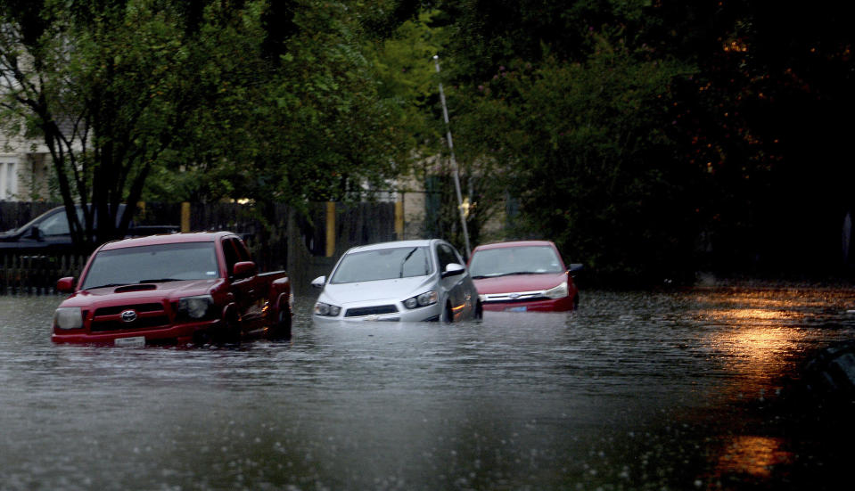 Streets in Old Town are flooded as heavy storm bands continue to batter the region Thursday morning, Sept. 19, 2019, in Beaumont, Texas. The remnants of Tropical Storm Imelda unleashed torrential rains in parts of Texas, prompting hundreds of water rescues, a hospital evacuation and road closures as the powerful storm system quickly drew comparisons to 2017's Hurricane Harvey. (Kim Brent/The Beaumont Enterprise via AP)