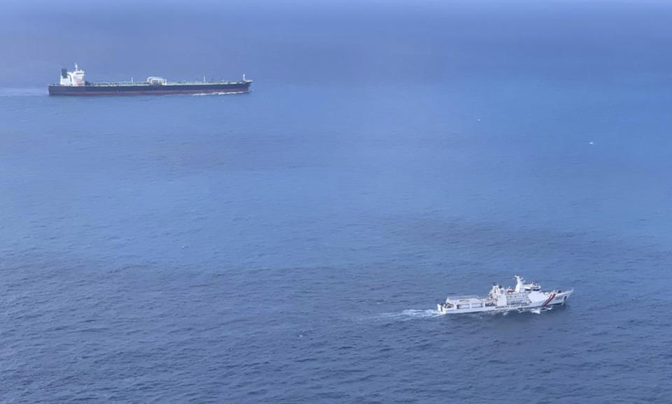 In this undated photo released by Indonesian Maritime Security Agency (BAKAMLA), a BAKAMLA ship escorts Iranian-flagged tanker MT Horse, top left, as they sail towards Batam Island, Indonesia. Indonesian authorities detained the crews MT Horse and Panamanian-flagged MT Freya that were seized Sunday for illegally transferring oil in Indonesian waters, an official said Tuesday. (Indonesian Maritime Security Agency via AP)