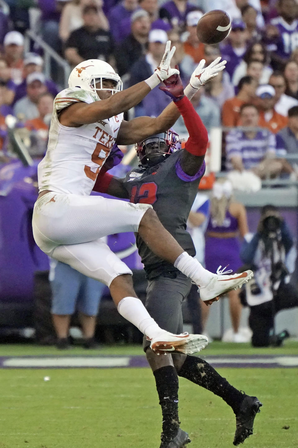 TCU cornerback Jeff Gladney (12) breaks up a pass intended for Texas wide receiver Collin Johnson (9) in the second half of an NCAA college football game in Fort Worth, Texas, Saturday, Oct. 26, 2019. (AP Photo/Louis DeLuca)