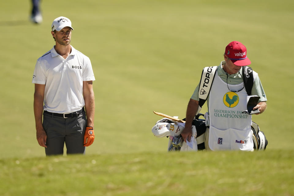 Thomas Detry, of Belgium, looks down the ninth fairway while his caddie checks his yardage book during the second day of the Sanderson Farms Championship golf tournament in Jackson, Miss., Friday, Sept. 30, 2022. (AP Photo/Rogelio V. Solis)