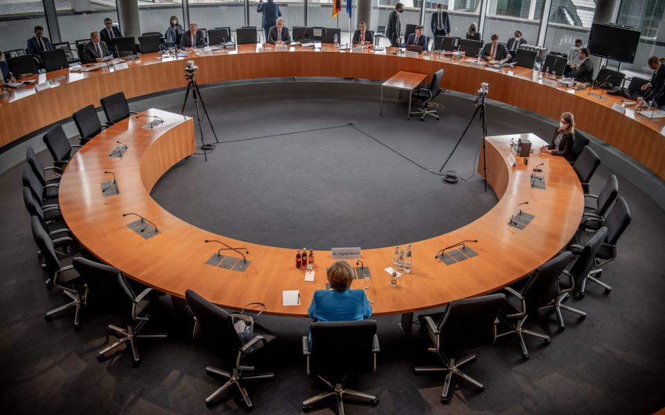 German Chancellor Angela Merkel is seated for questioning  - MICHAEL KAPPELER/POOL/EPA-EFE/Shutterstock