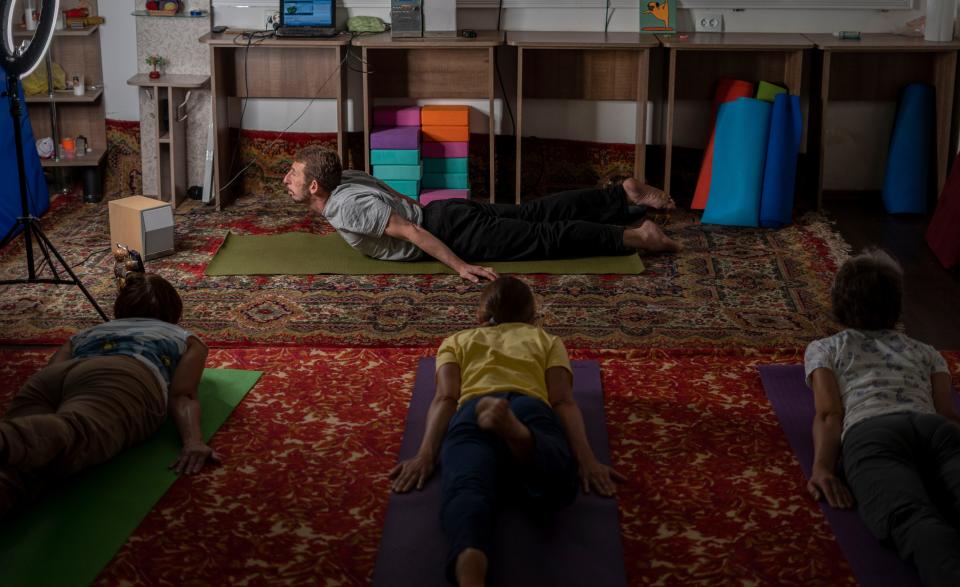 Serhii Zaloznyi, center, holds a yoga session in a basement in Kramatorsk, Donetsk region, on Thursday, Sept. 14, 2023. People gather three times a week for yoga to alleviate the stress caused by Russia’s constant shelling.