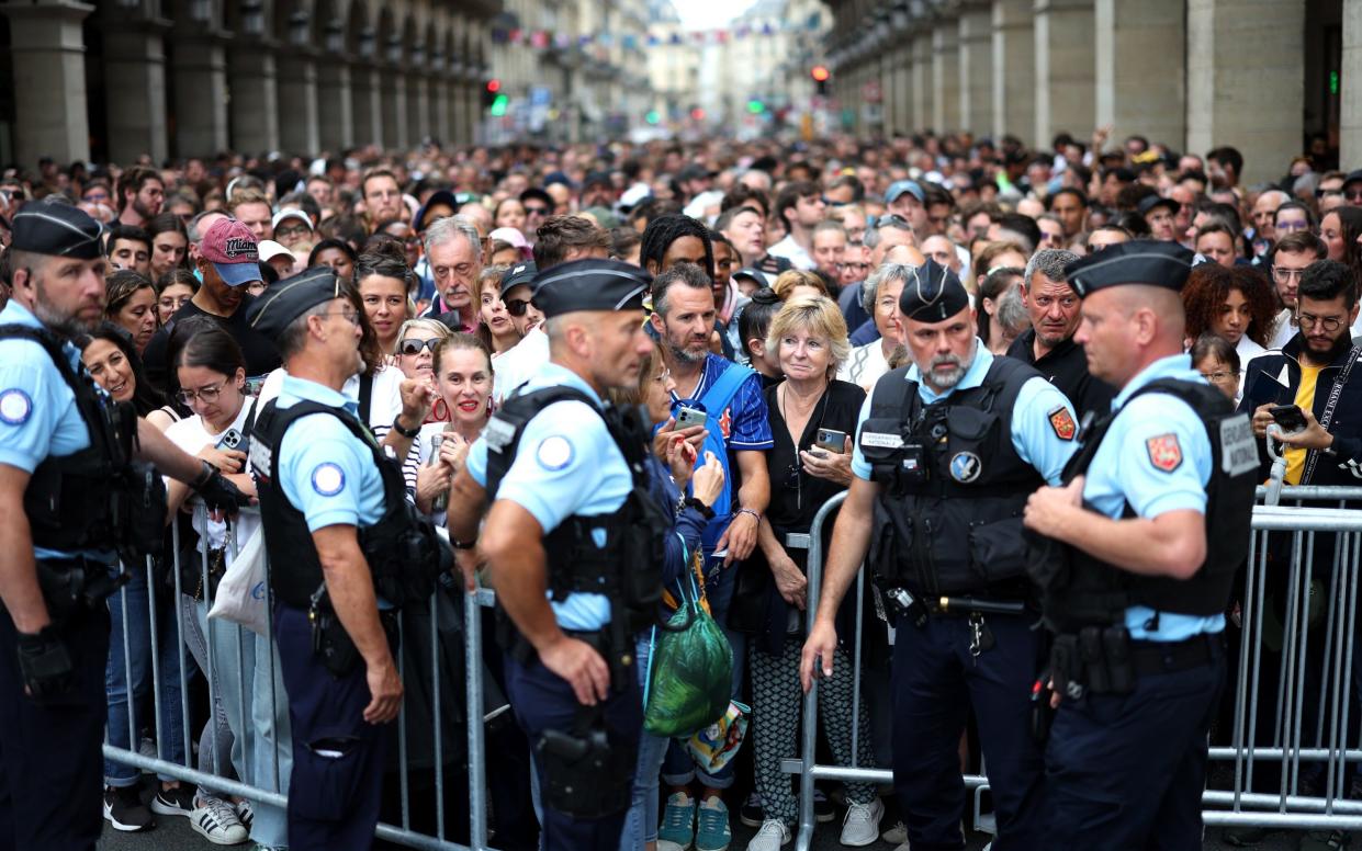 Police officers prepare for security checks prior to the opening ceremony of the Paris 2024 Olympic Games