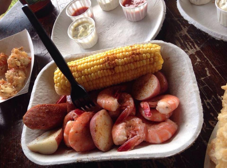 <p>This classic low country dish from South Carolina (also called <a href="https://www.thedailymeal.com/recipes/classic-idaho-potato-low-country-boil-grill-packets-recipe?referrer=yahoo&category=beauty_food&include_utm=1&utm_medium=referral&utm_source=yahoo&utm_campaign=feed" rel="nofollow noopener" target="_blank" data-ylk="slk:low country boil;elm:context_link;itc:0;sec:content-canvas" class="link ">low country boil</a> or Beaufort stew) is the perfect way to enjoy the region’s ample culinary offerings. Similar to your standard seafood boil, Frogmore stew is traditionally made with fresh Carolina <a href="https://www.thedailymeal.com/recipes/peel-and-eat-shrimp-recipe-0?referrer=yahoo&category=beauty_food&include_utm=1&utm_medium=referral&utm_source=yahoo&utm_campaign=feed" rel="nofollow noopener" target="_blank" data-ylk="slk:shrimp;elm:context_link;itc:0;sec:content-canvas" class="link ">shrimp</a>, yellow corn, redskin potatoes, sausage and occasionally crabs, seasoned with lemon juice and Old Bay or Zatarain’s seasoning. Like most proper boils, it’s dumped out onto a newspaper-topped table and served on paper plates with plenty of cold beer. Head to Bowen's Island restaurant in Charleston to sample the real deal. </p>