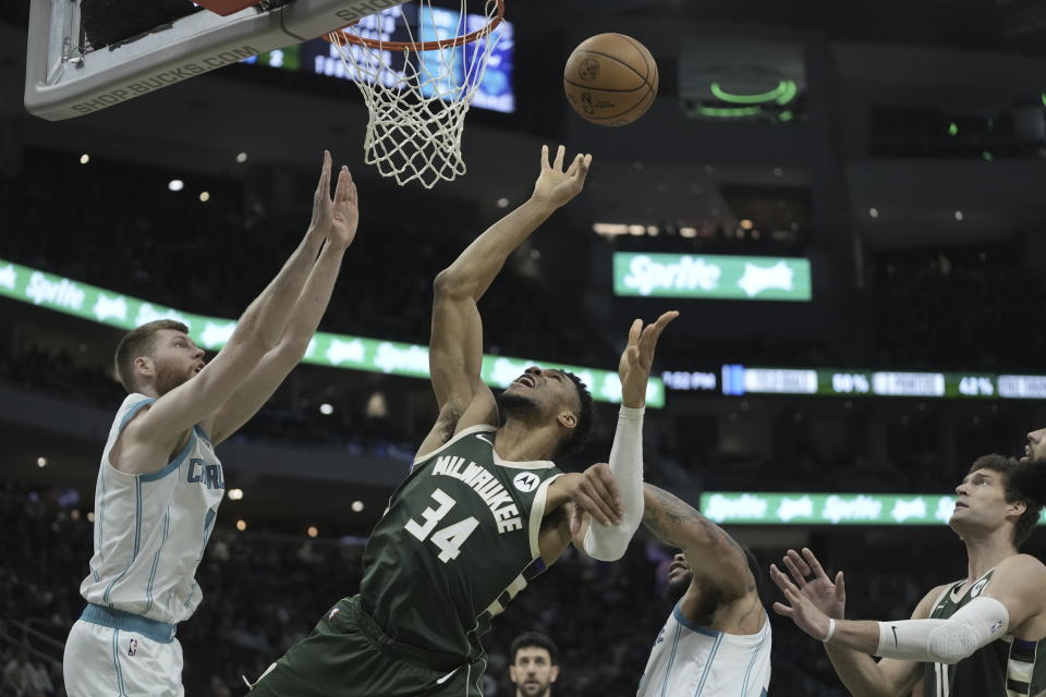 Charlotte Hornets' Miles Bridges fouls Milwaukee Bucks' Giannis Antetokounmpo during the first half of an NBA basketball game Tuesday, Feb. 27, 2024, in Milwaukee. (AP Photo/Morry Gash)