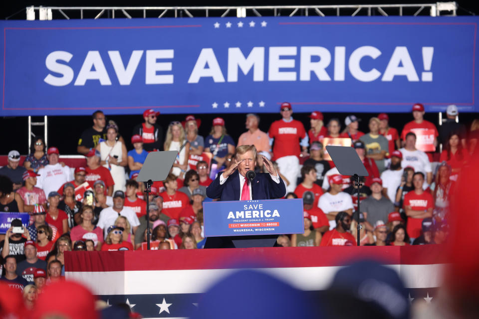 Former President Donald Trump speaks to supporters under a banner that reads: Save America!