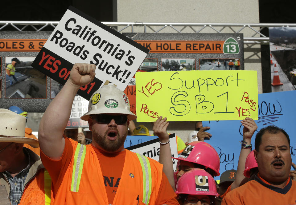 FILE - In this April 5, 2017, file photo, supporters of a plan for a $5 billion-a-year tax and fee road repair measure rally at the Capitol in Sacramento, Calif. Democratic lawmakers argue President Donald Trump's administration is cutting away at health, environmental and workplace safety protections. Their plan is to keep in place federal rules that pre-date Trump. SB1, which is awaiting a vote in the Senate, says many federal standards in place before Trump took office would still be enforceable under state law even if the federal government changes its policies. (AP Photo/Rich Pedroncelli, File)