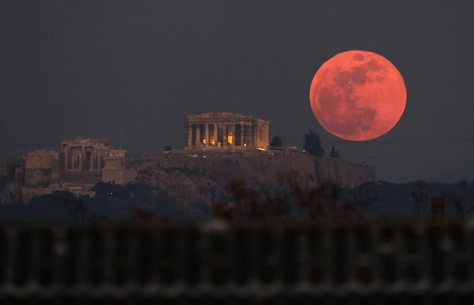 A super blue blood moon rises behind the 2,500-year-old Parthenon temple on the Acropolis of Athens, Greece, on Wednesday, Jan. 31, 2018. On Wednesday, much of the world got to see not only a blue moon which is a supermoon, but also a lunar eclipse, all rolled into one celestial phenomenon. (AP Photo/Petros Giannakouris)