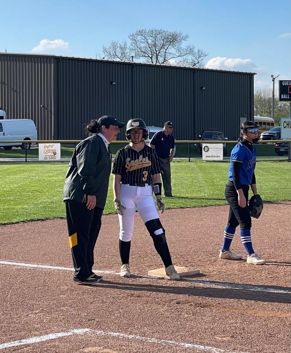 Colonel Crawford's Harley Thomas talks to coach Sarah Fraser on third base.