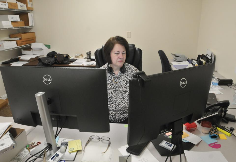 Director of Client Services Lorraine Cabral goes through incoming emails and voicemails Monday morning. The Cape Cod Times Needy Fund is changing its name to the Cape Cod Times Neighbors Fund.