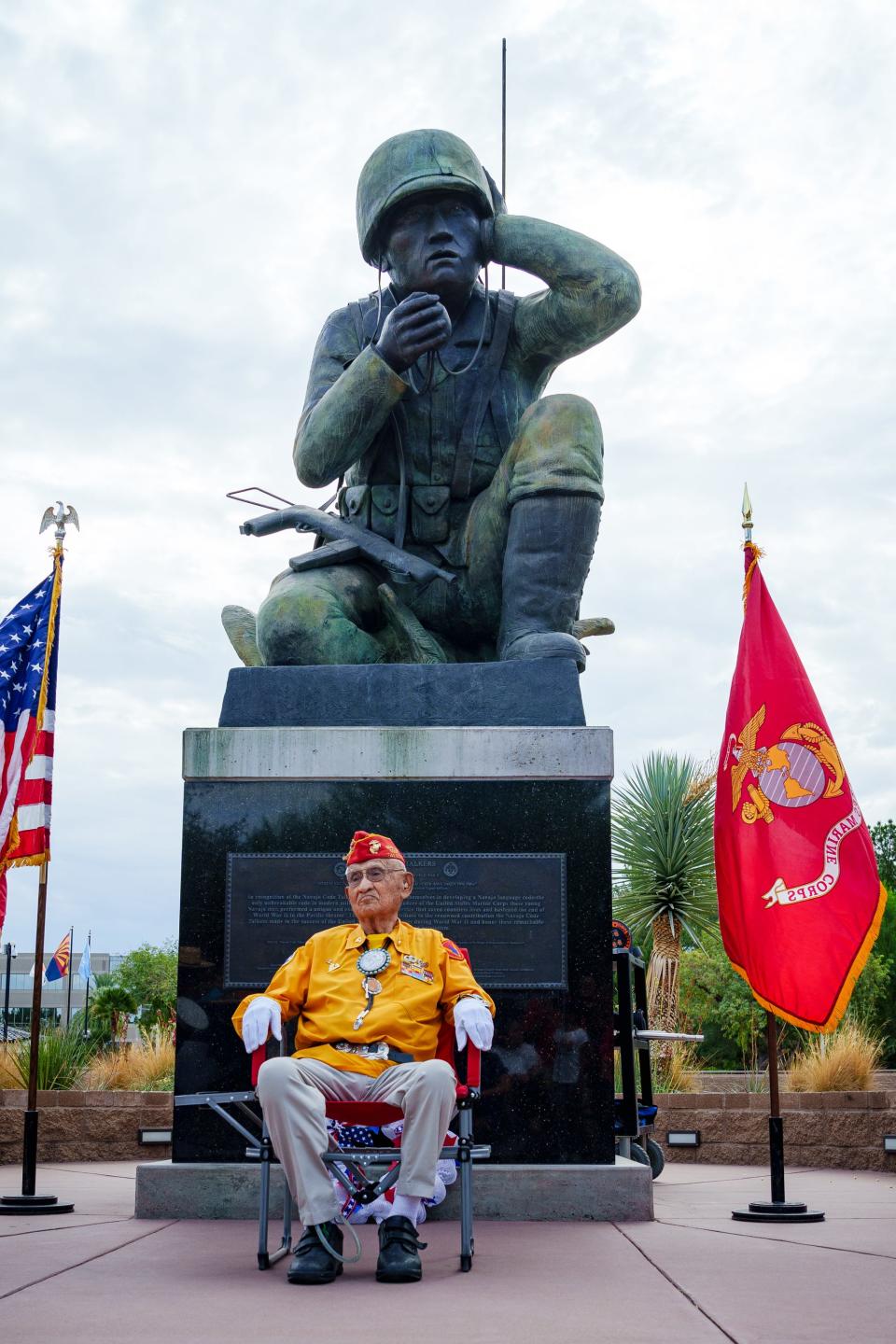 Navajo Code Talker Thomas H. Begay sits for photos in front of the Navajo Code Talkers memorial at the Wesley Bolin Plaza in Phoenix on Aug. 14, 2022.