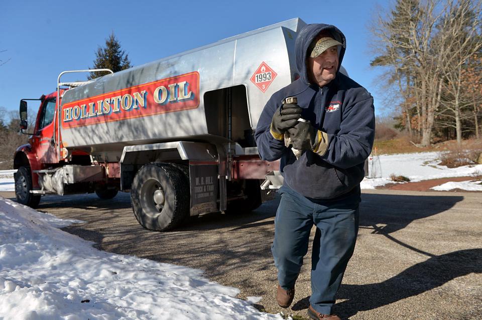 Holliston Oil's Tom LoRicco makes an oil delivery on Fisk Pond Road in Holliston, Massachusetts, when the temperature was 10 degrees in January 2022.