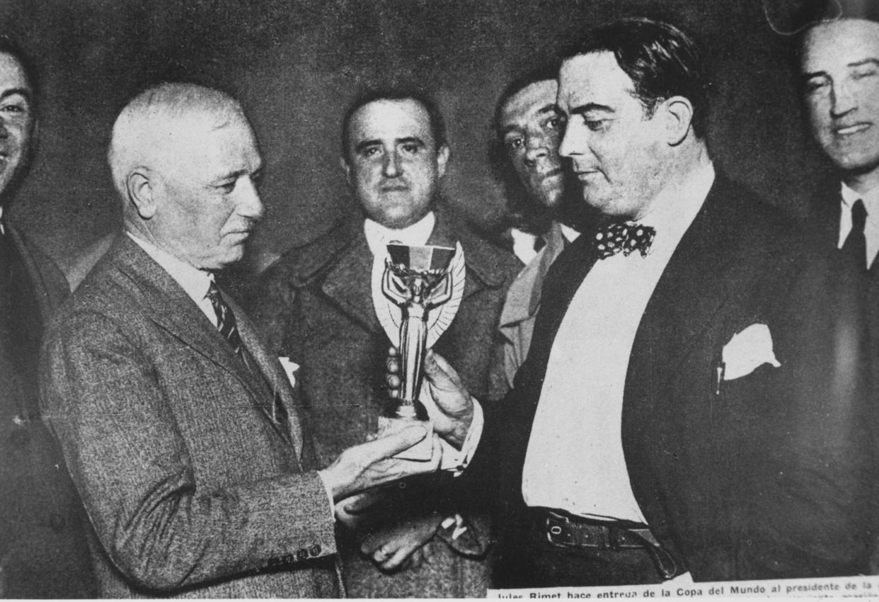 Jules Rimet (left) president of FIFA, presents the first World Cup trophy (the Jules Rimet Trophy) to Dr Paul Jude, the president of the Uruguayan Football Association, after Uruguay beat Argentina 4-2 in the first ever World Cup final in 1930. (Getty)