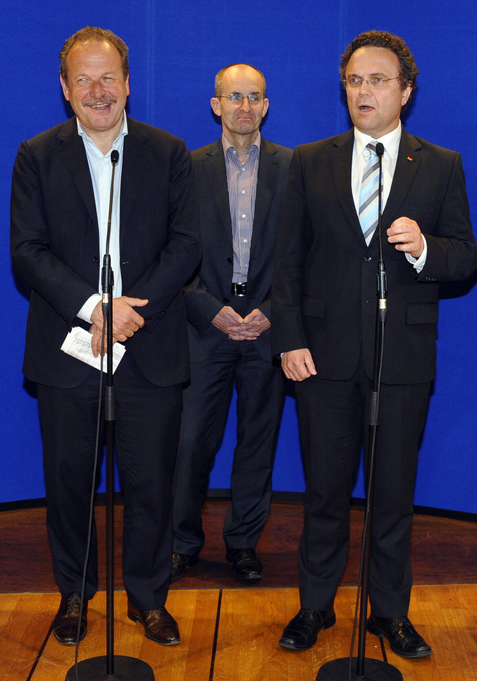 Leader of the union ver.di Frank Bsirske and German Interior Minister Hans-Peter Friedrich, front from left, brief the media in Potsdam, Germany Saturday, March 31, 2012, after marathon talks that followed a series of walkouts in recent weeks. Some 2 million German public-sector employees are to get a pay rise totaling 6.3 percent over two years. The hard-fought agreement banishes the ver.di union's threat to ballot members on an all-out strike campaign had a deal not been reached. (AP Photo/dapd, Theo Heimann)