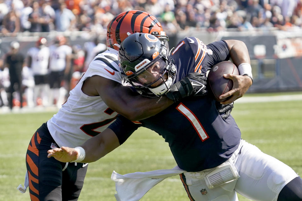 Chicago Bears quarterback Justin Fields (1) carries the ball and is tackled by Cincinnati Bengals cornerback Chidobe Awuzie during the second half of an NFL football game Sunday, Sept. 19, 2021, in Chicago. (AP Photo/Nam Y. Huh)