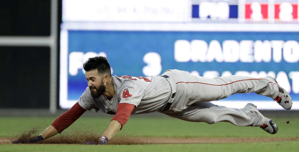 Boston Red Sox starting pitcher Rick Porcello dives into second base after hitting a double off Philadelphia Phillies starting pitcher Nick Pivetta during the third inning of a baseball game, Tuesday, Aug. 14, 2018, in Philadelphia. (AP Photo/Matt Slocum)