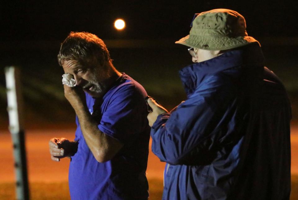 Anti-death penalty supporter Randy Gardner, left, wipes away a tear - Credit: AP