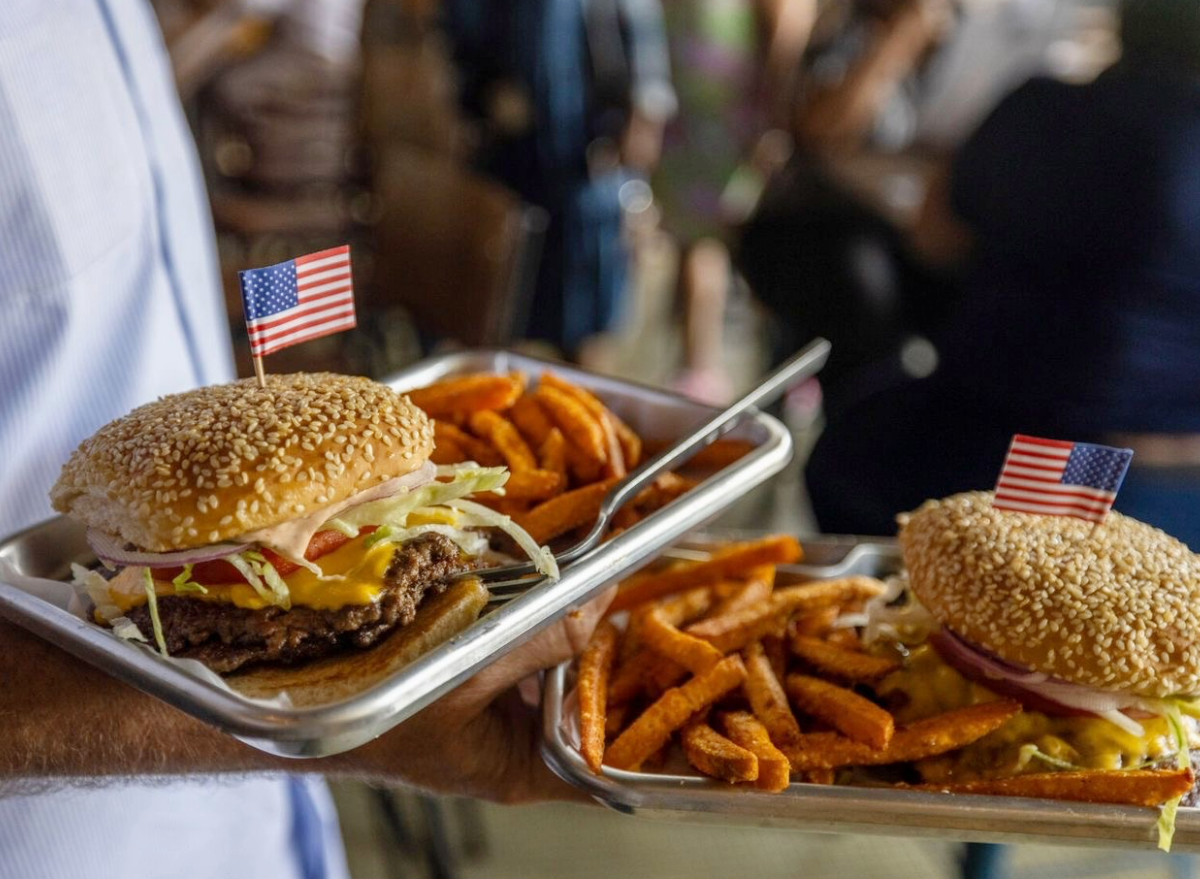 heavy's barburgers being served on a platter with sweet potato fries.