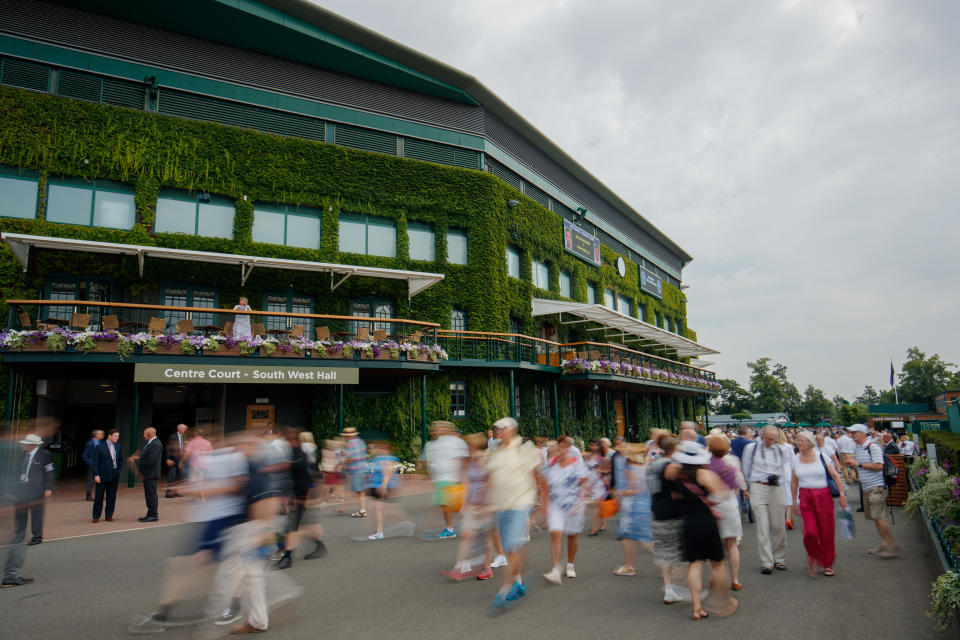 Motion blur of fans walking past around Centre Court on grounds of the All England Lawn Tennis Club, home to Wimbledon Championships