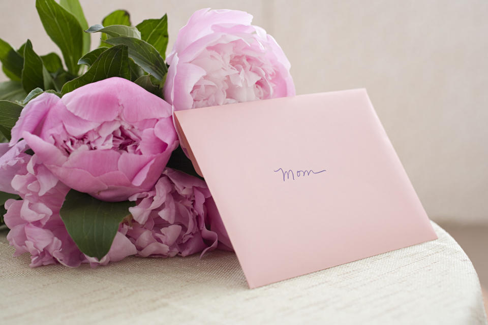 A bouquet of flowers with a card that reads, "Mom"