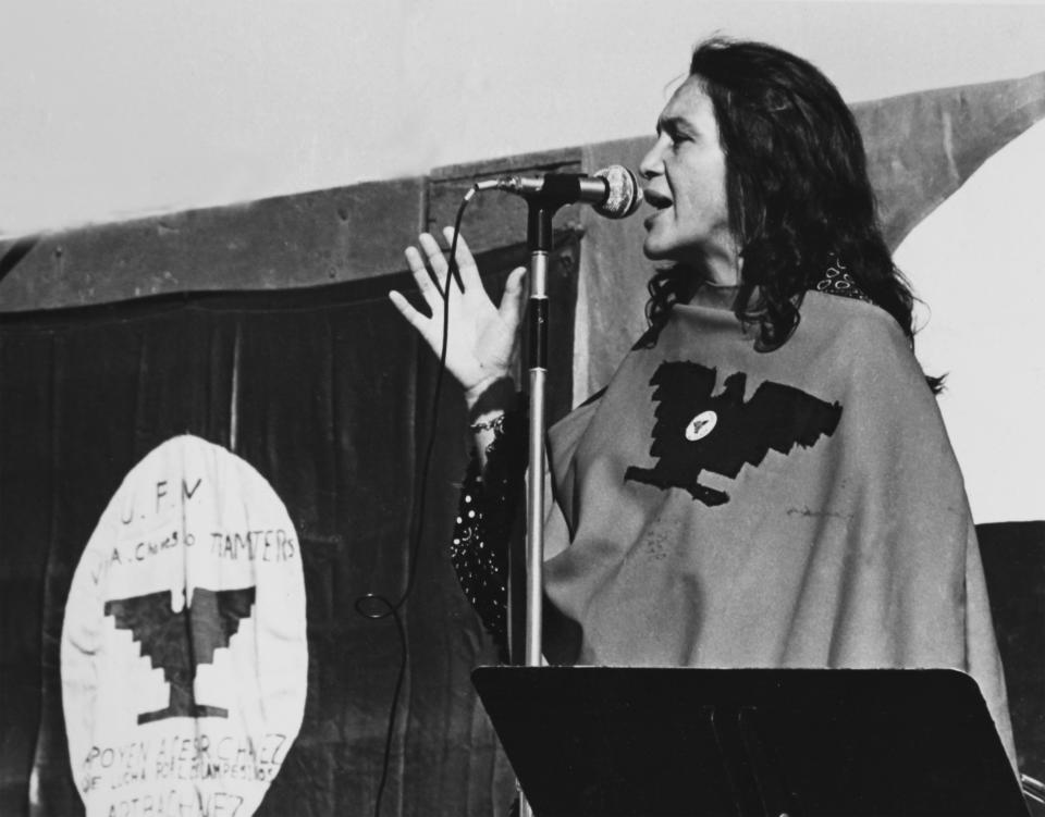 American labor activist and co-founder of the United Farm Workers of America (UFW) Dolores Huerta speaks on stage during a UFW rally, California, 1975 or 1976. She wears a poncho with the UFW logo. (Photo by Cathy Murphy/Getty Images)<span class="copyright">Getty Images</span>