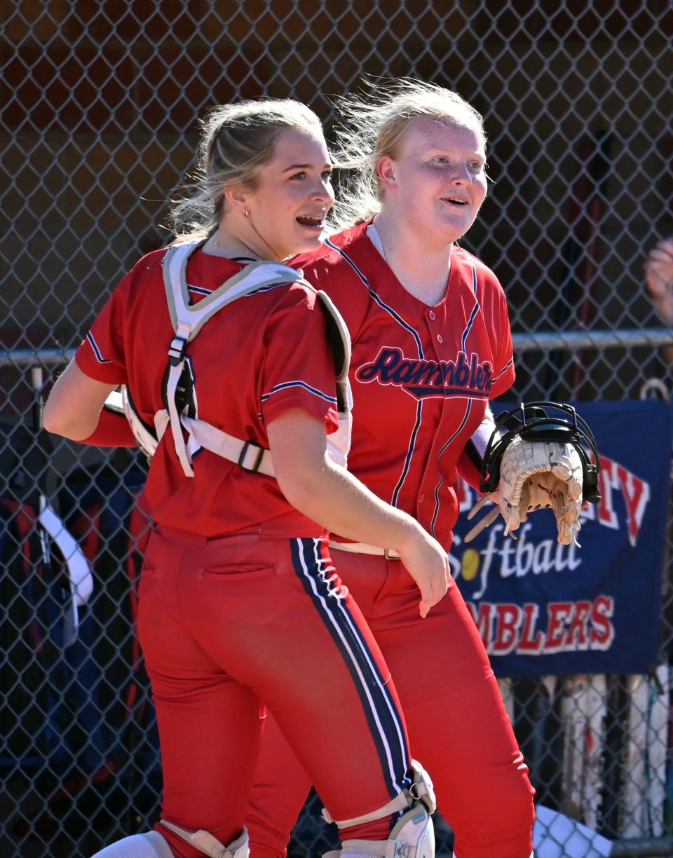 Boyne City's Delaney Vollmer (right) and Katelyn Dittmar (left) celebrate an out to get out of the inning during the opening matchup against Inland Lakes Monday.