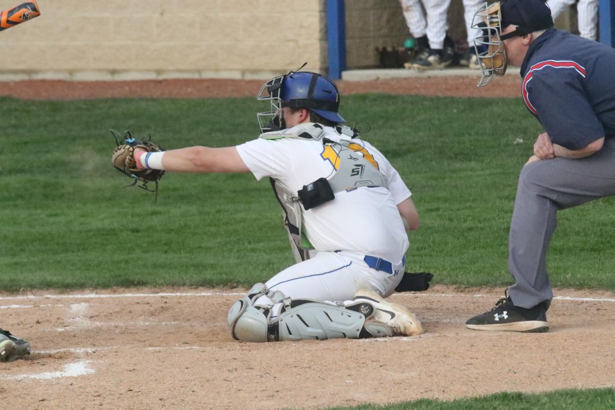 Ontario catcher Jake Chapman uses an electronic communication device attached to his chest protector during a game against Galion earlier this season.