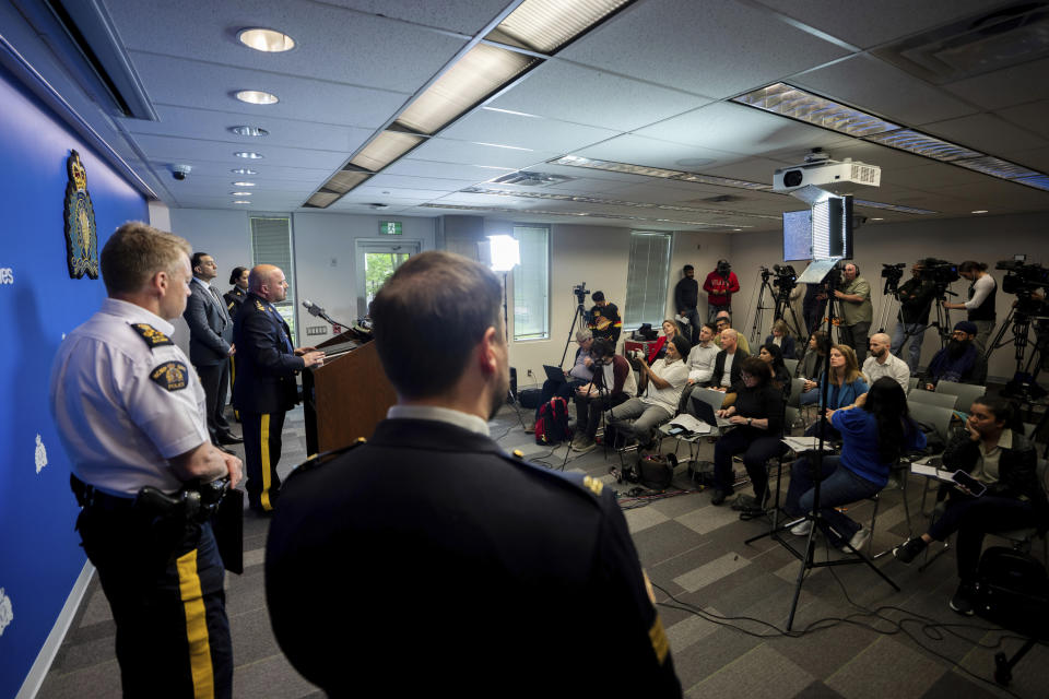 Media ask questions to Assistant Commissioner David Teboul, centre, Commander of the Federal Policing Program in the Pacific Region, during a news conference for an update on the Hardeep Singh Nijjar homicide investigation from June 18, 2023, in Surrey, B.C., Friday, May 3, 2024. (Ethan Cairns/The Canadian Press via AP)