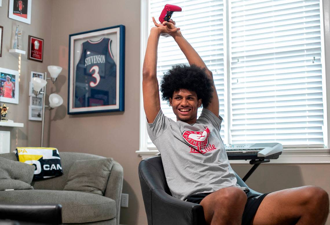 Jarin Stevenson stretches his long arms after a round of video gaming against his brother Cameron Stevenson, during his last evening at home on Tuesday, June 27, 2023 in Chapel Hill, N.C. Jarin would depart the next morning for Tuscaloosa, Ala. after committing to the University of Alabama.