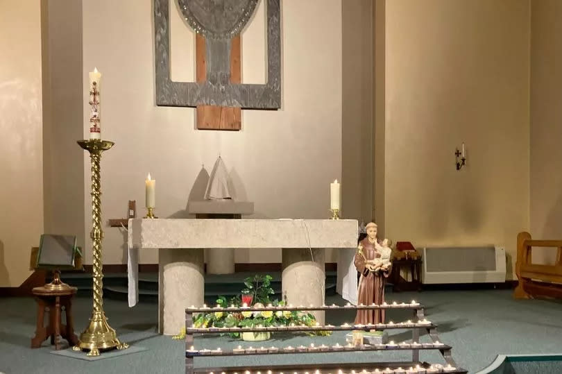 The altar at St Joseph's Church during the service for Jacob's family, with several lit candles