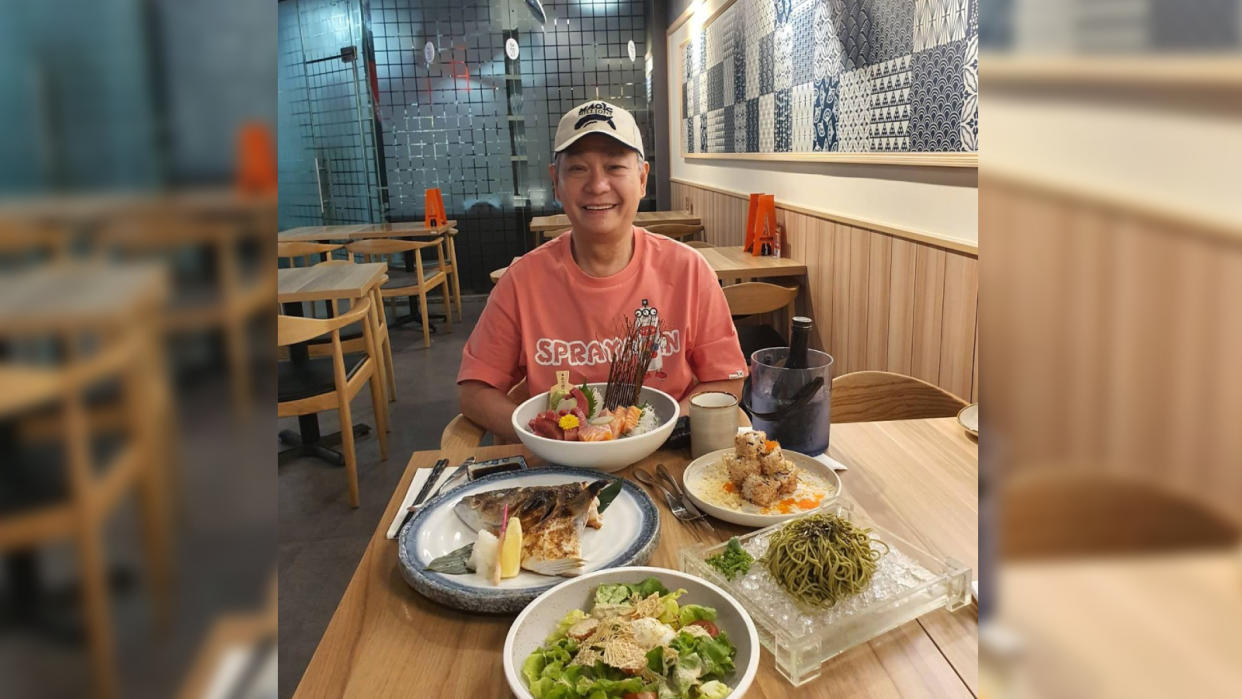 Local actor Richard Low posed in front of Japanese dishes, including soba and sashimi.