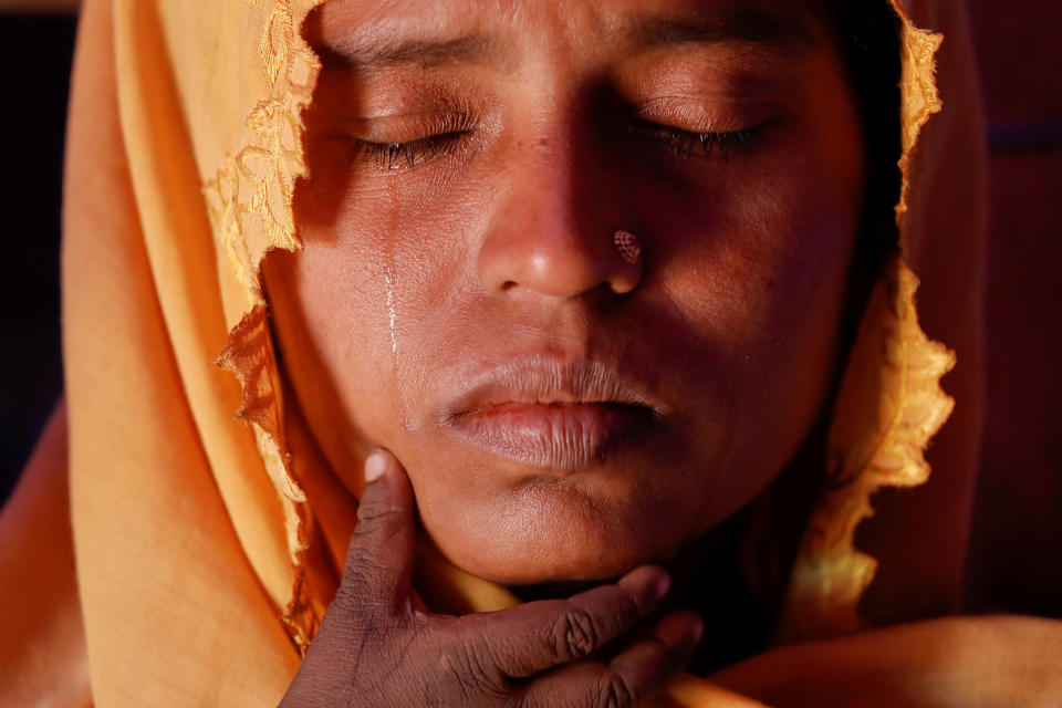 Roshid Jan, a Rohingya refugee who said she is not sure of her age, cries holding her son Muhammad Gyab at their shelter at the camp for widows and orphans inside the Balukhali camp near Cox's Bazar, Bangladesh, on Dec. 5. Roshid Jan, who walked for 10 days with her five children to Bangladesh after soldiers burned their village, wept when she spoke about her missing husband. The religious leader in their Phansi village in Myanmar's Rakhine State was accused of being a member of the Rohingya militants and arrested 11 months ago, she said. She had not seen him or heard about his fate since then. Now she lives with her five children and more than 230 others at camp for Rohingya widows and orphans. Reuters photographer Damir Sagolj: "Three hills away from the nearest road, in a dusty valley of Balukhali refugee camp, a patchwork of densely packed red tents hides an ocean of grief and pain. Some call it a red camp for its colour, others a long camp because of its shape but it's best known for those who found shelter there. 'This is a widows camp,' its unofficial and energetic leader explained after I introduced myself. In about 50 tents, over 230 women and children live. There are no men. As I was listening the stories of widows and orphans this camp shelters, I realized it's difficult to imagine a place with more sorrow than this. The camp seemed like a place in which the whole Rohingya tragedy is condensed."