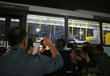 Broken windows on an official media bus after they shattered when driving accredited journalists to the Main Transport Mall from the Deodoro venue of the Rio 2016 Olympic Games in Rio de Janeiro, August 9, 2016. REUTERS/Adrees Latif