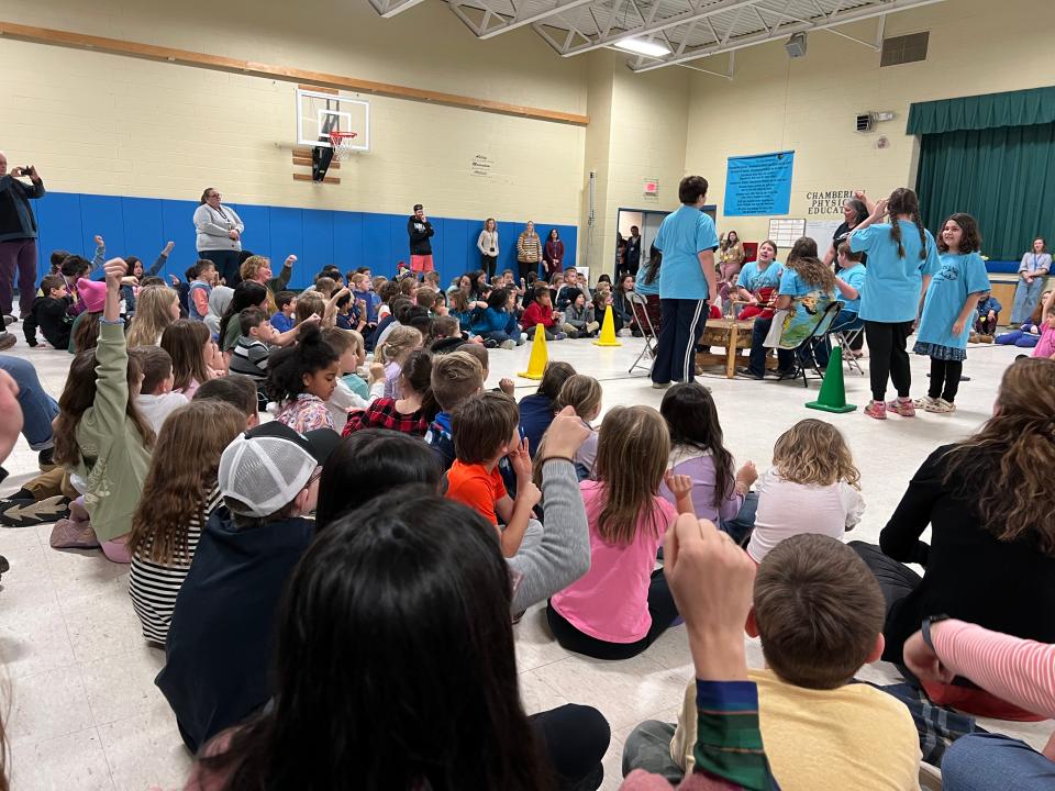 Students at Gertrude Chamberlin School in South Burlington show appreciation for a drumming performance in the traditional Abenaki way by nodding their fist up and down, rather than clapping. Eight members of the Abenaki Circle of Courage program in Swanton performed at the school on Nov. 14, 2023.