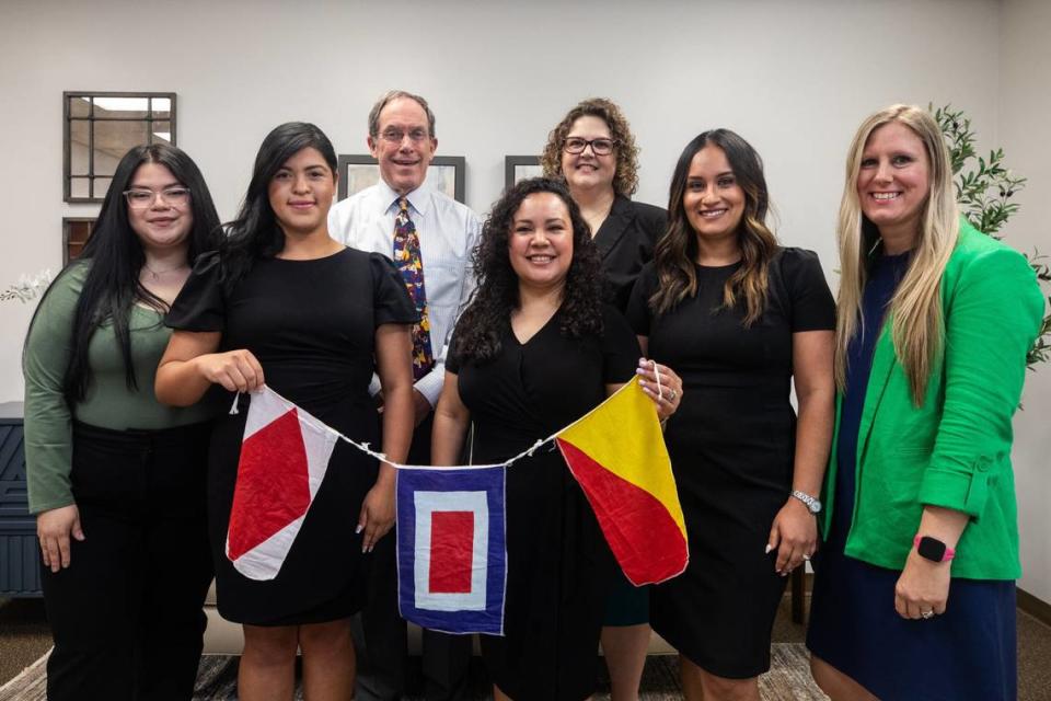 Members of the Methodist Justice Ministry hold up International Maritime signal flags at the First United Methodist Church in Fort Worth. 