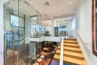 <p>The open-concept two-floor design is best viewed from the foyer, which also features a glass elevator and modular stairs. </p>