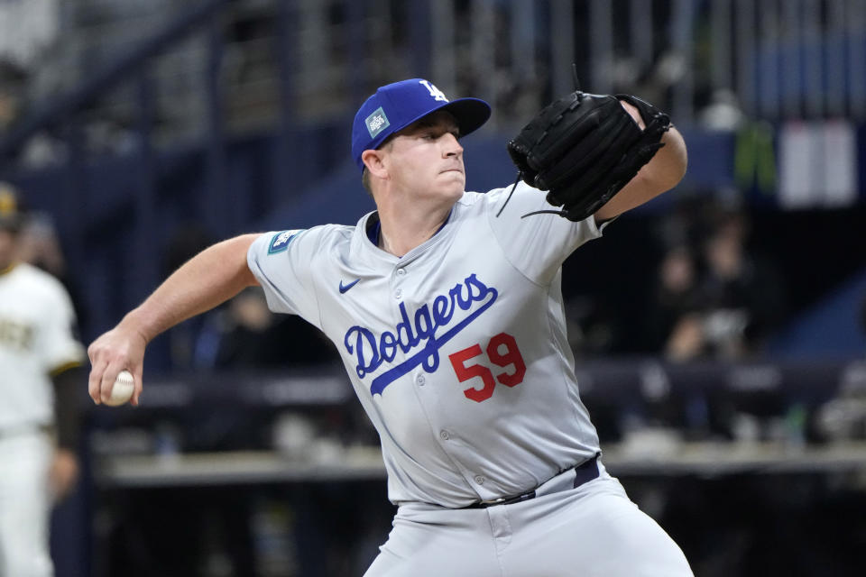 Los Angeles Dodgers relief pitcher Evan Phillips throws to the plate during the ninth inning of an opening day baseball game against the San Diego Padres at the Gocheok Sky Dome in Seoul, South Korea Wednesday, March 20, 2024, in Seoul, South Korea. (AP Photo/Ahn Young-joon)