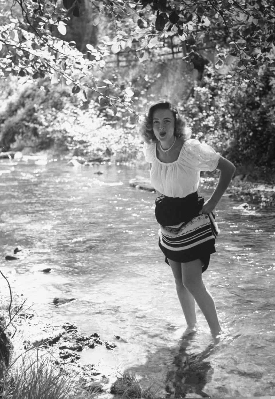 Reed hoisting up her skirt in an undated image as she crosses Saratoga Creek, a fishing spot in Santa Clara County, California.&nbsp;