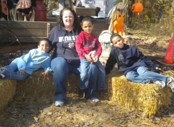 Jennifer Flewellen takes a photo with her three sons, Skylar, Daeton and Julian, in this undated photo.