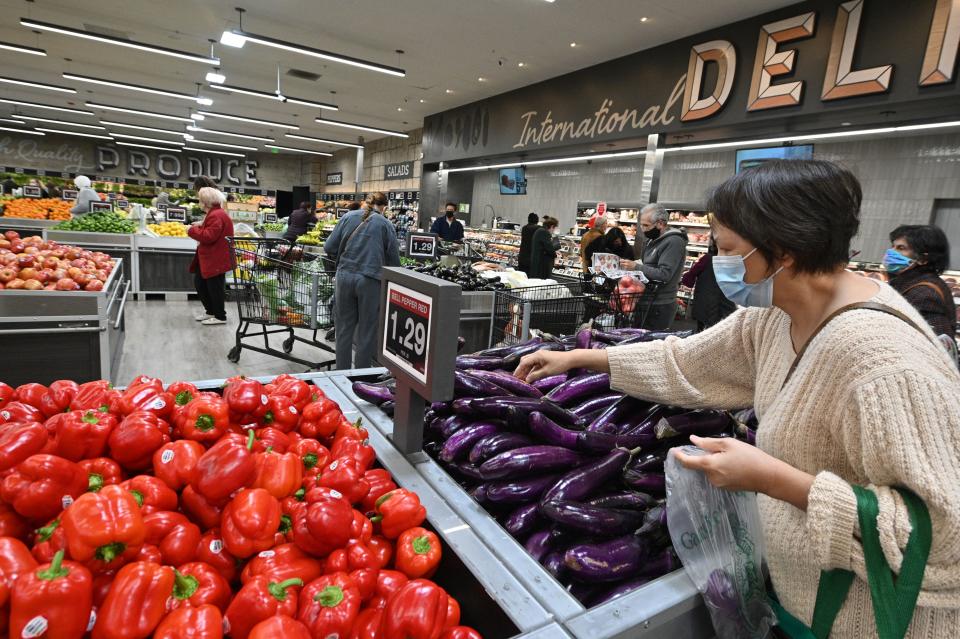 People shop for groceries at a supermarket in Glendale, California January 12, 2022. - The seven percent increase in the Labor Department's consumer price index (CPI) over the 12 months to December was the highest since June 1982, as prices rose for an array of goods especially housing, cars and food. (Photo by Robyn Beck / AFP) (Photo by ROBYN BECK/AFP via Getty Images)