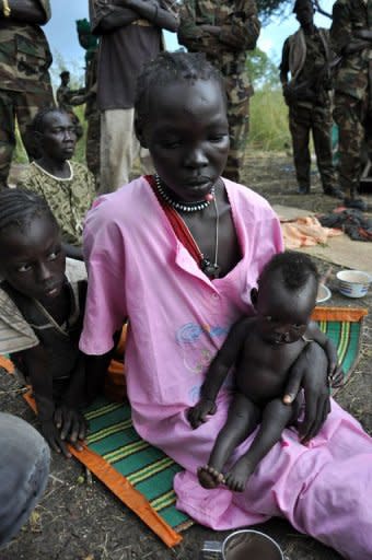 Twenty-one-year-old Huwa Gundi sits on the ground next to a makeshift tent after fleeing the village of Maiyas in Kurmuk region of the Blue Nile state