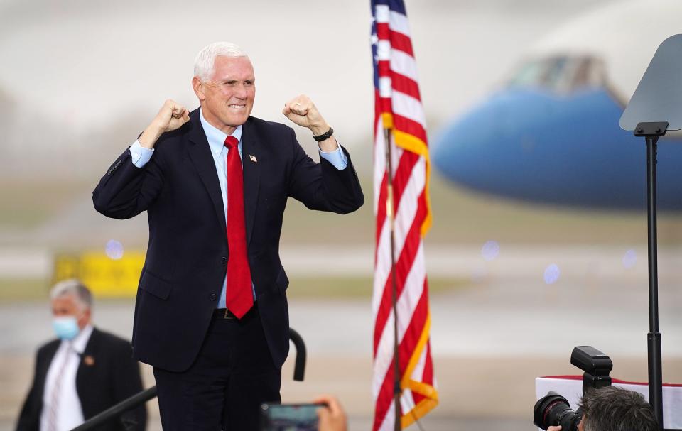 Vice President Mike Pence arrives on stage to greet a crowd at Port City Air at the Portsmouth International Airport at Pease on Wednesday, October 21, 2020. 