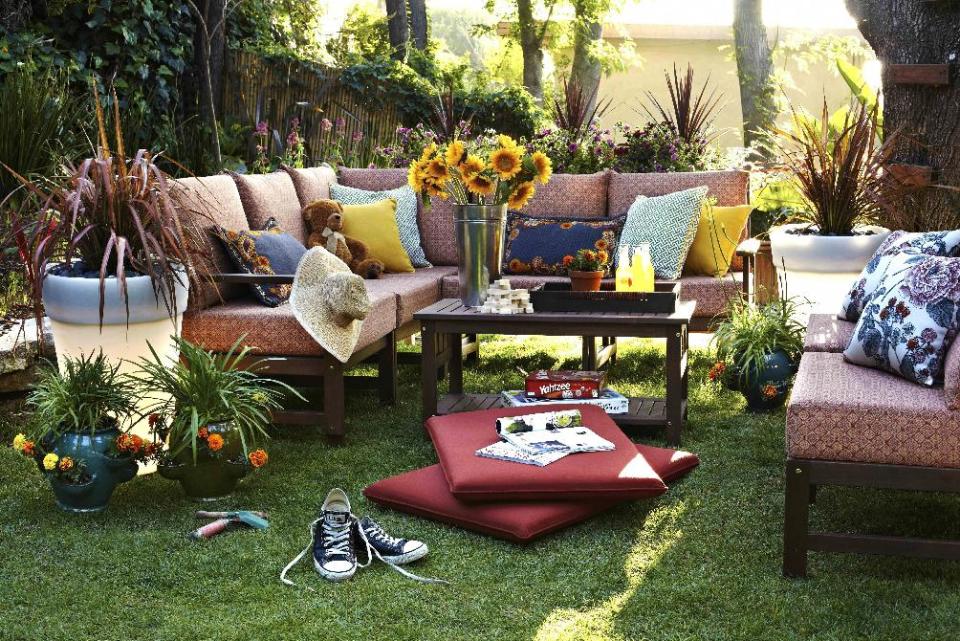 This publicity photo provided by Brian Patrick Flynn shows light-up plastic planters added to an outdoor family room to give it nighttime use by designer Brian Patrick Flynn for Hayneedle.com. In order for the planter to work, it simply requires being plugged into a nearby outlet with its attached cord and an extension cord. (AP Photo/Brian Patrick Flynn, Daniel J. Collopy)