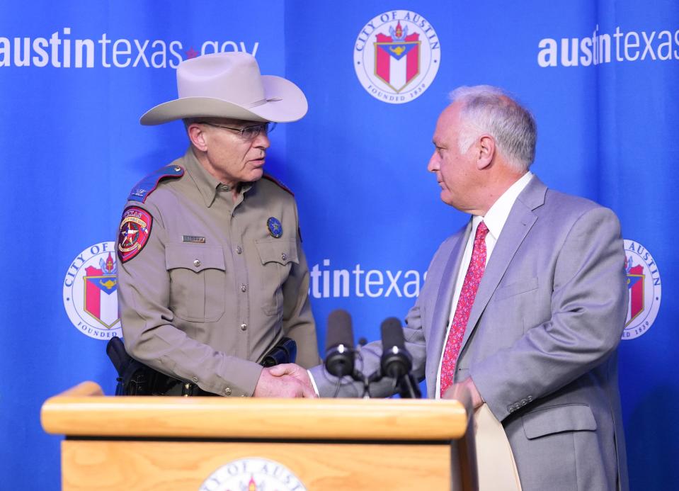 Mayor Kirk Watson shakes hands with Texas Department of Public Safety Director Steven McCraw at a news conference at City Hall in March about a new plan to keep Austin safe during public safety staffing shortages.