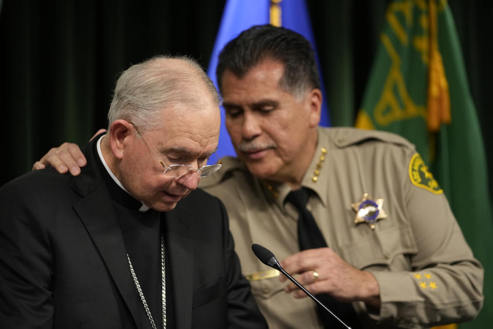 Los Angeles County Sheriff Robert Luna, right, hugs Archbishop of Los Angeles, Jose H. Gomez during a news conference announcing an arrest has been made in connection to the murder of Catholic auxiliary bishop David O'Connell, who was fatally shot over the weekend in Hacienda Heights, at a news conference at the Hall of Justice Monday, Feb. 20, 2023 in Los Angeles. Luna says a SWAT team arrested Carlos Medina in the morning at his home in Torrance, about 35 miles (56 kilometers), southwest of Hacienda Heights, where Auxiliary Bishop David O'Connell was killed. (AP Photo/Damian Dovarganes)