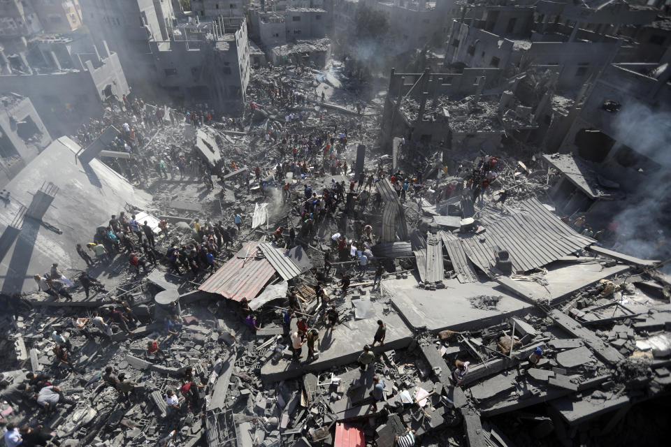 Palestinians inspect the rubble of destroyed buildings following Israeli airstrikes on the town of Khan Younis, southern Gaza Strip, Thursday, Oct. 26, 2023. (AP Photo/Mohammed Dahman)