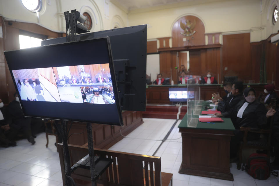 A monitor is displayed as a trial starts in Surabaya, East Java, Indonesia , Monday, Jan, 16, 2023. An Indonesian court began trial Monday against five men on charges of negligence leading to deaths of 135 people after police fired tear gas inside a soccer stadium, setting off a panicked run for the exits in which many were crushed. (AP Photo/Trisnadi)