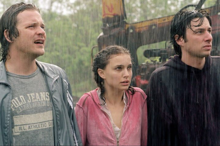 Peter Sarsgaard, Natalie Portman, and Zach Braff stand in the pouring rain in Garden State.