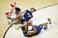 Oral Roberts' Kevin Obanor, bottom, looks to pass after recovering the ball during a scrum involving teammate Kareem Thompson, center, and Ohio State's Justice Sueing during the second half of a first-round game in the NCAA men's college basketball tournament, Friday, March 19, 2021, at Mackey Arena in West Lafayette, Ind. Oral Roberts won in overtime. (AP Photo/Robert Franklin)